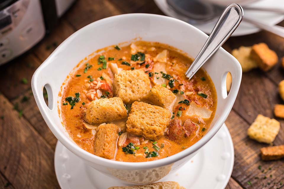 Tomato bisque in a white bowl.