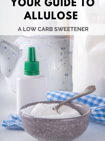 A bowl of allulose with a spoon, a bottle of sweetener, and a checkered cloth are on a counter. Text on the image: "Your Guide to Allulose: A Low Carb Sweetener." Website: laraclevenger.com. Discover how allulose can transform your low-carb lifestyle!