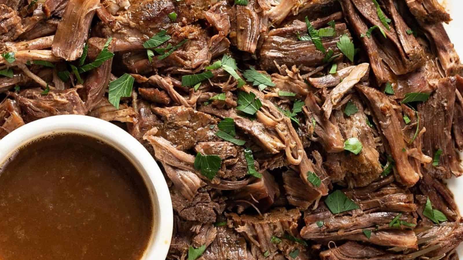 A bowl of instant pot roast beef with gravy and vegetables.
