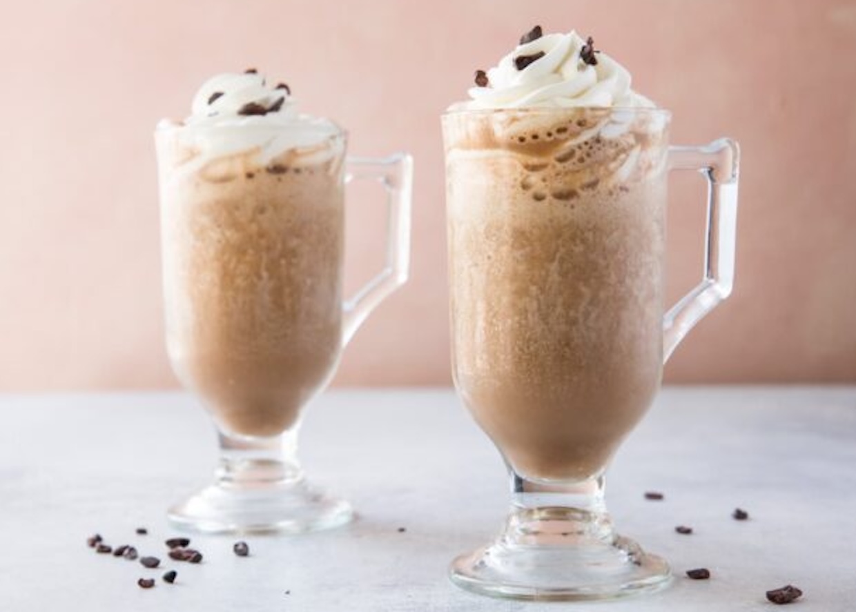 2 frozen coffee drinks topped with whipped cream.