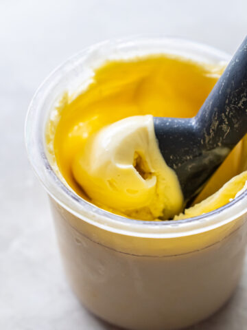 mango ice cream with an ice cream scoop.