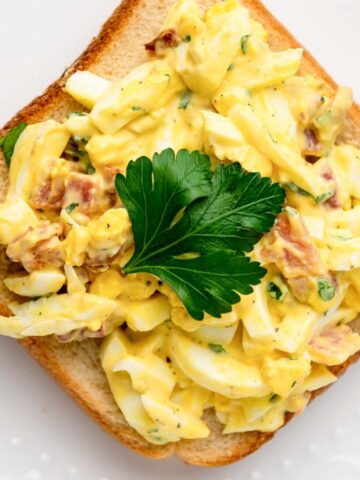 loaf bread top with Bacon and Egg Salad in a plate