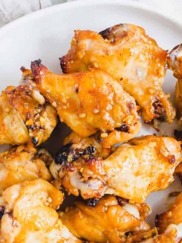salty and sticky wings in a plate