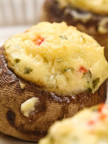 mushrooms are stuffed with a delicious filling made with cream cheese, cheddar cheese, bell peppers, and parsley