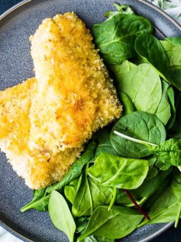 fish fillet and a leaves in a plate