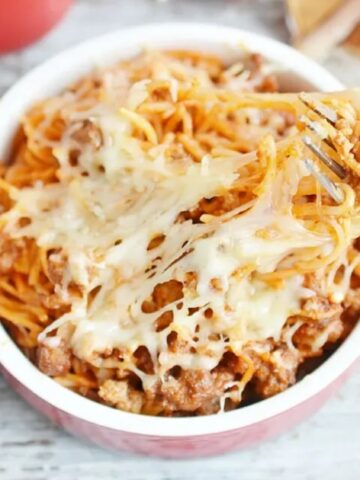 spaghetti top with mozzarella cheese in a casserole
