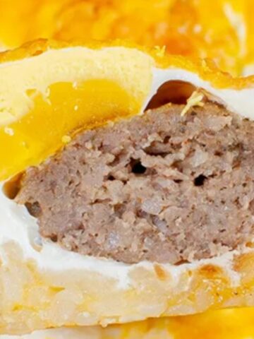 half slice muffin with egg and sausage on the inside