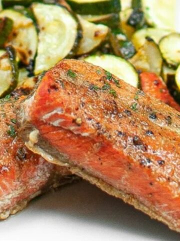 honey garlic salmon with zucchini and lemon on the side.