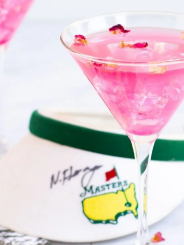 pink drink on a cocktail glass with tennis cap background