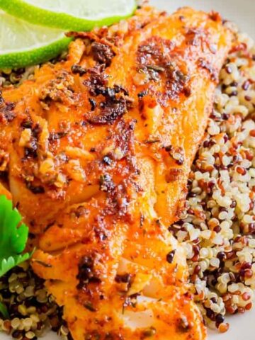 pan seared blackened cod over quinoa with lime and parsley on the side