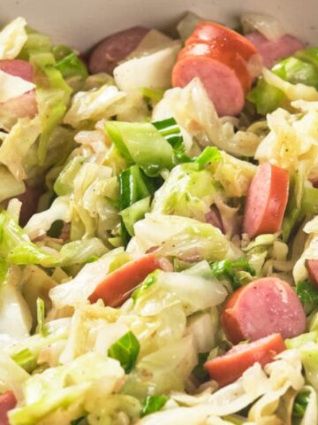 cabbage with sausage in a skillet pan