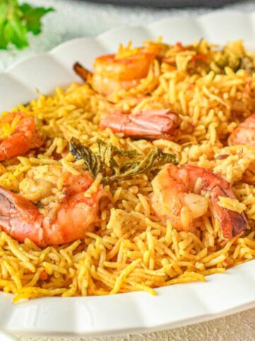 basmati rice top with shrimp in a oval plate