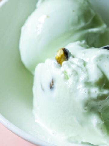 pistachio ice in a bowl with a scooper