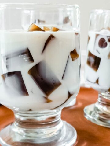 coffee jelly with milk on a glass with spoon on the side