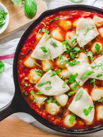 baked cauliflower gnocchi with ground pork, spinach, melted mozzarella cheese and fresh basil.