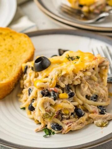 chicken, cheese, black beans, corn and pasta on a plate with toasted bread on the side