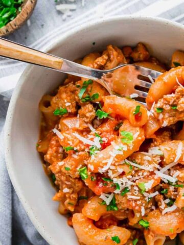 ground beef and pasta in a bowl with a fork