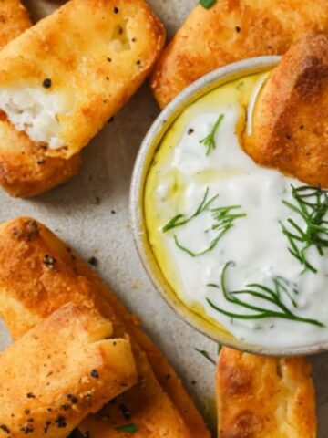 golden brown halloumi cheese fries with white sauce dip
