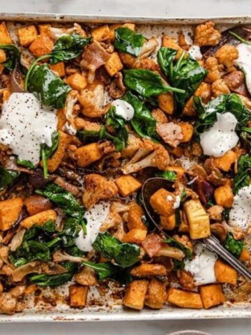 roasted Squash, Cauliflower, Onion, Bacon, And Spinach on a trey with sour cream