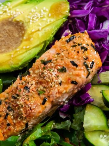 avocado, salmon, red cabbage cucumber and scallions on a bowl