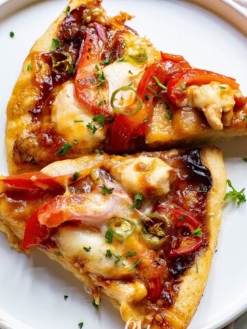 2 slices of BBQ chicken pizza on a saucer