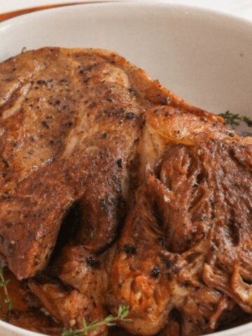 pork roast on a bowl garnished with rosemary