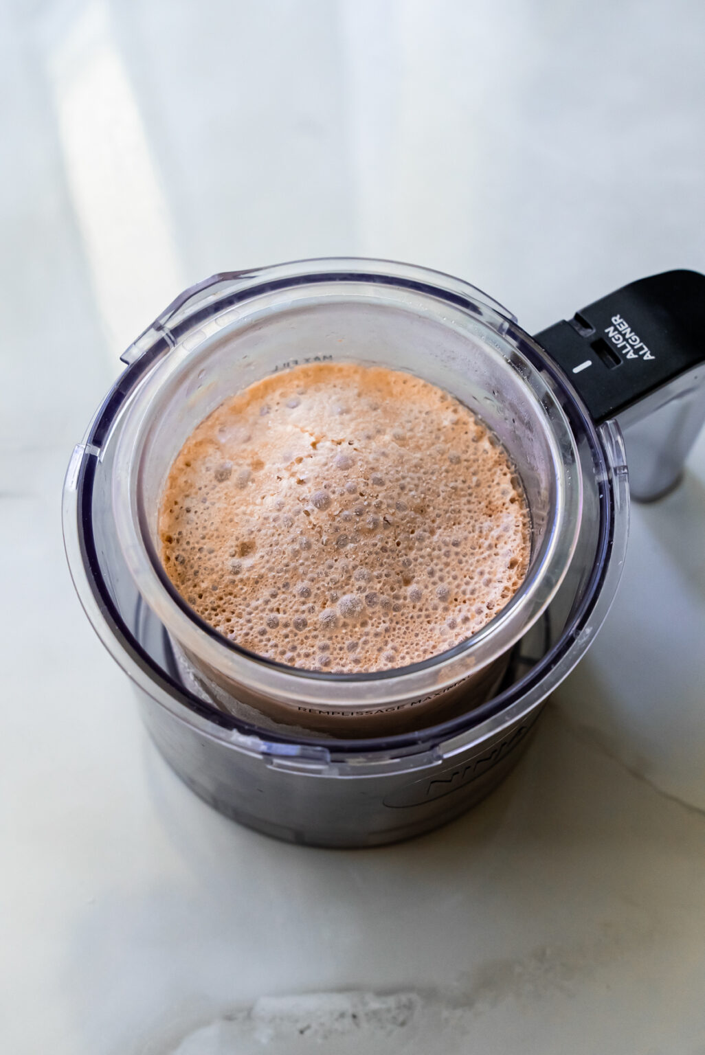 frozen liquid in a ninja creami pint.
