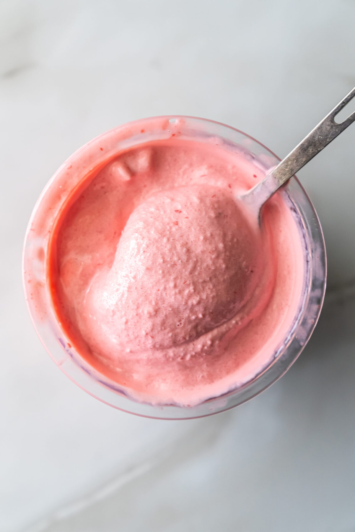cherry protein ice cream with a spoon.