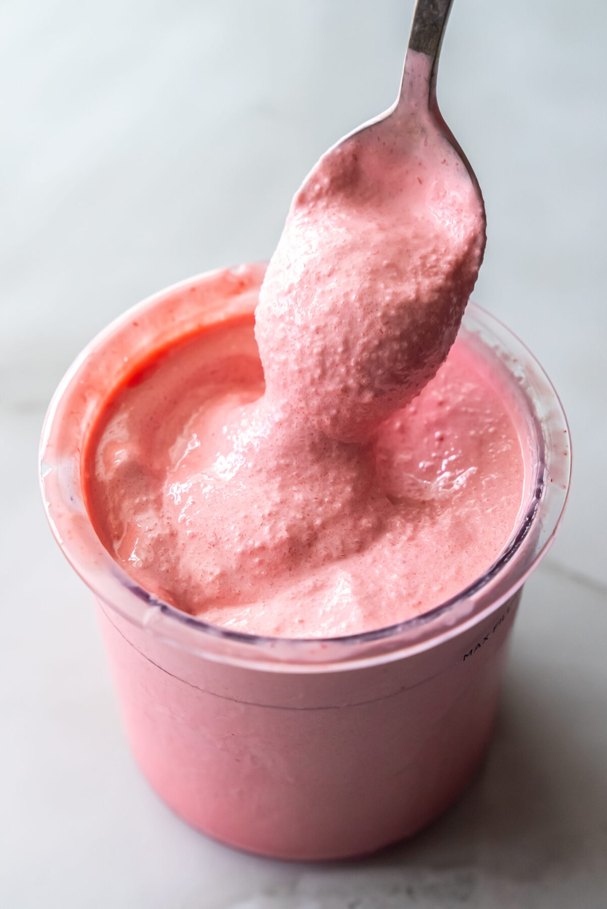 cherry protein ice cream with a spoon.