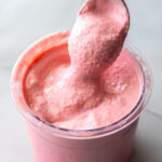 cherry protein ice cream with a spoon.