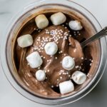 Dark Chocolate Protein Ice Cream with marshmallow, and spoon.