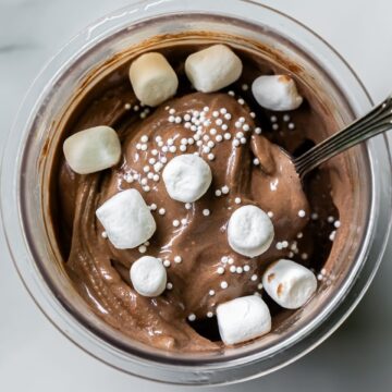 Dark Chocolate Protein Ice Cream with marshmallow, and spoon.