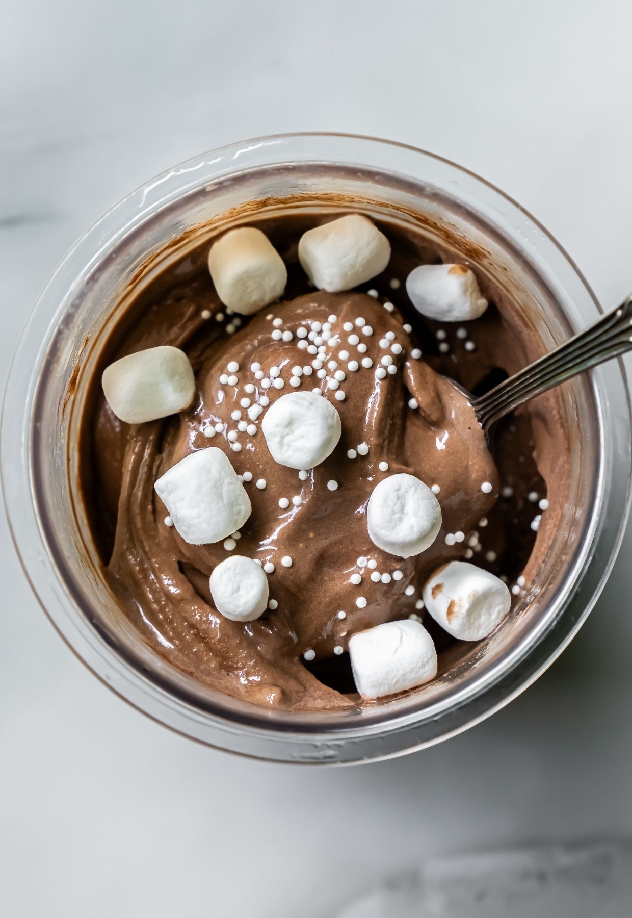 Dark Chocolate Protein Ice Cream with marshmallow, and spoon.