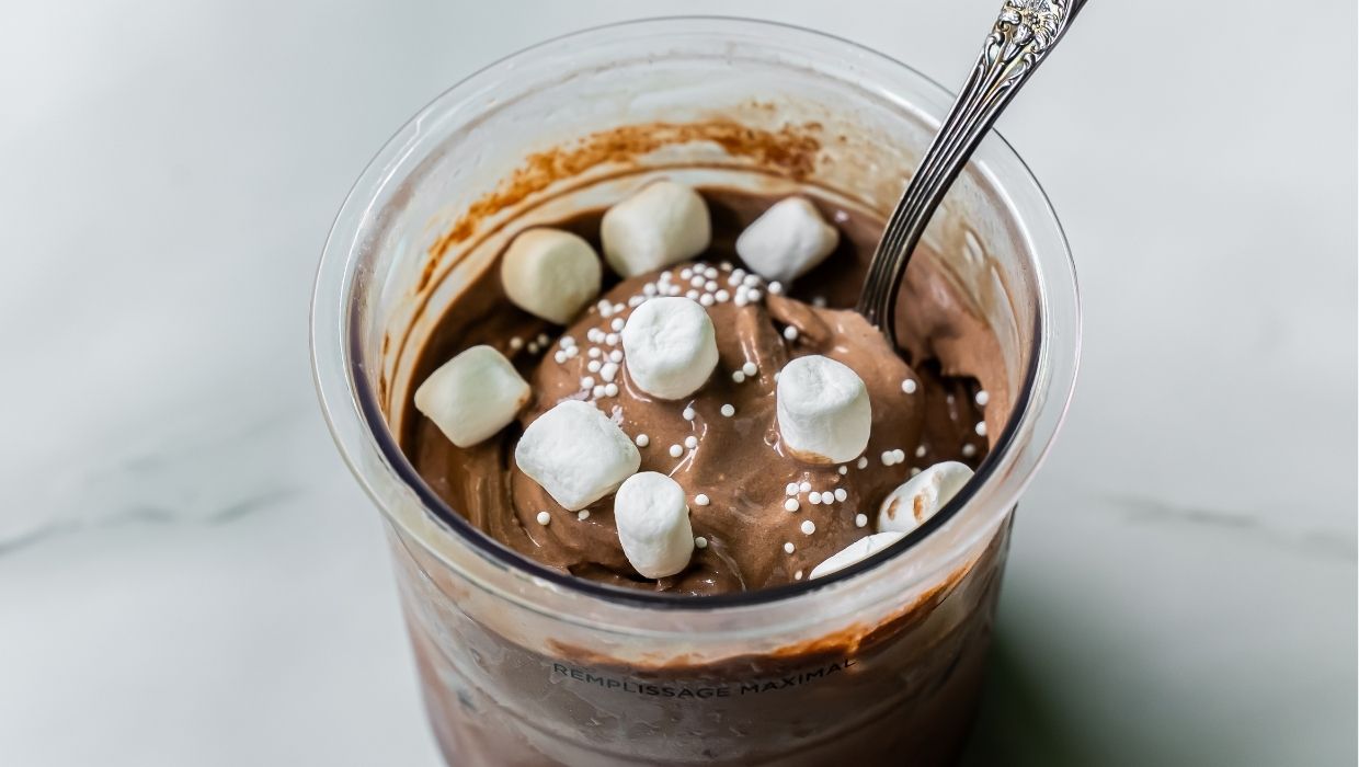Dark Chocolate Protein Ice Cream with marshmallow, and spoon.