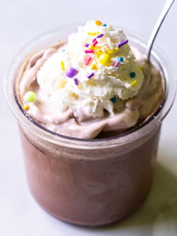 chocolate ice cream with whipped cream and sprinkles.