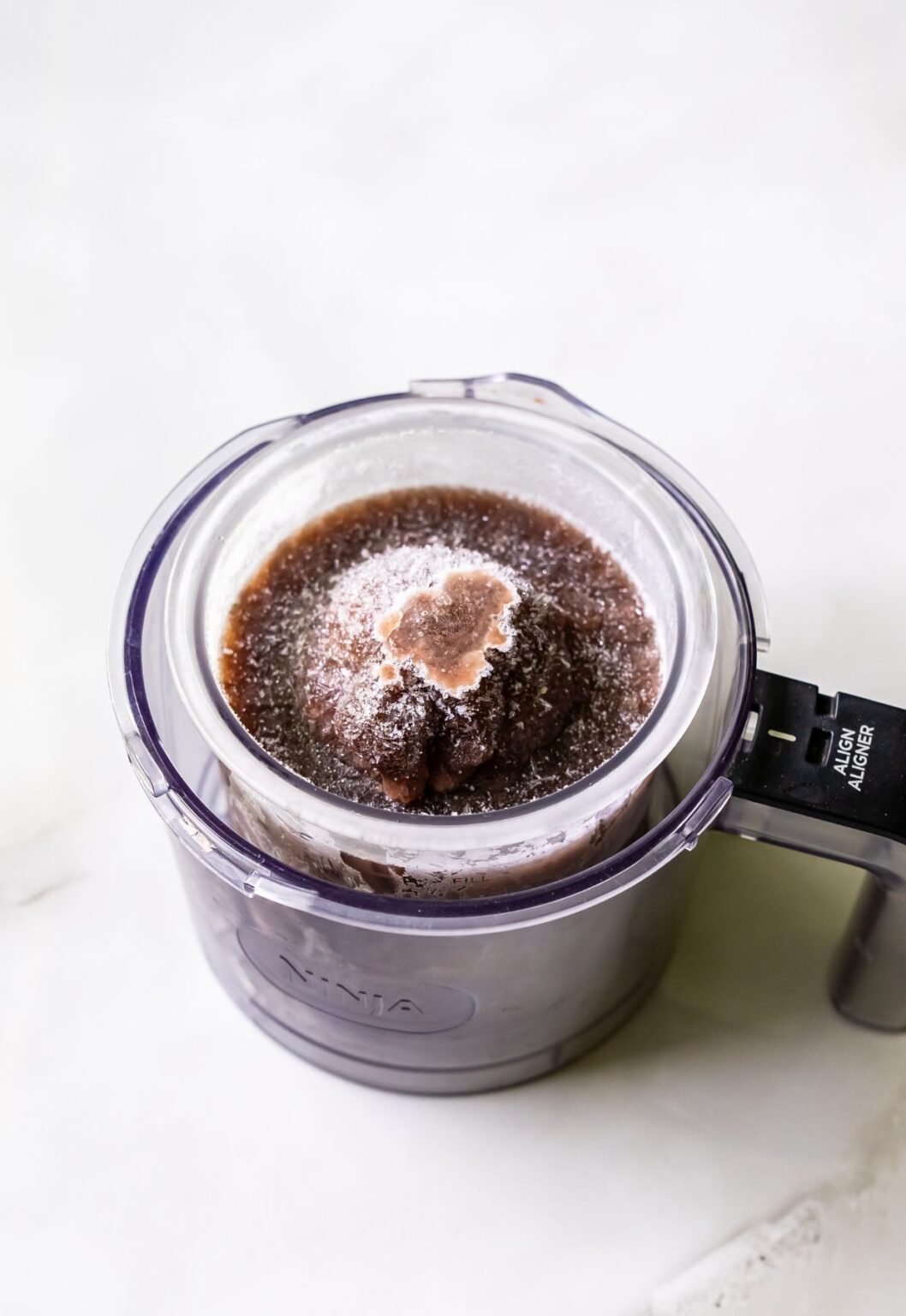 high protein chocolate ice cream in a clear pint.