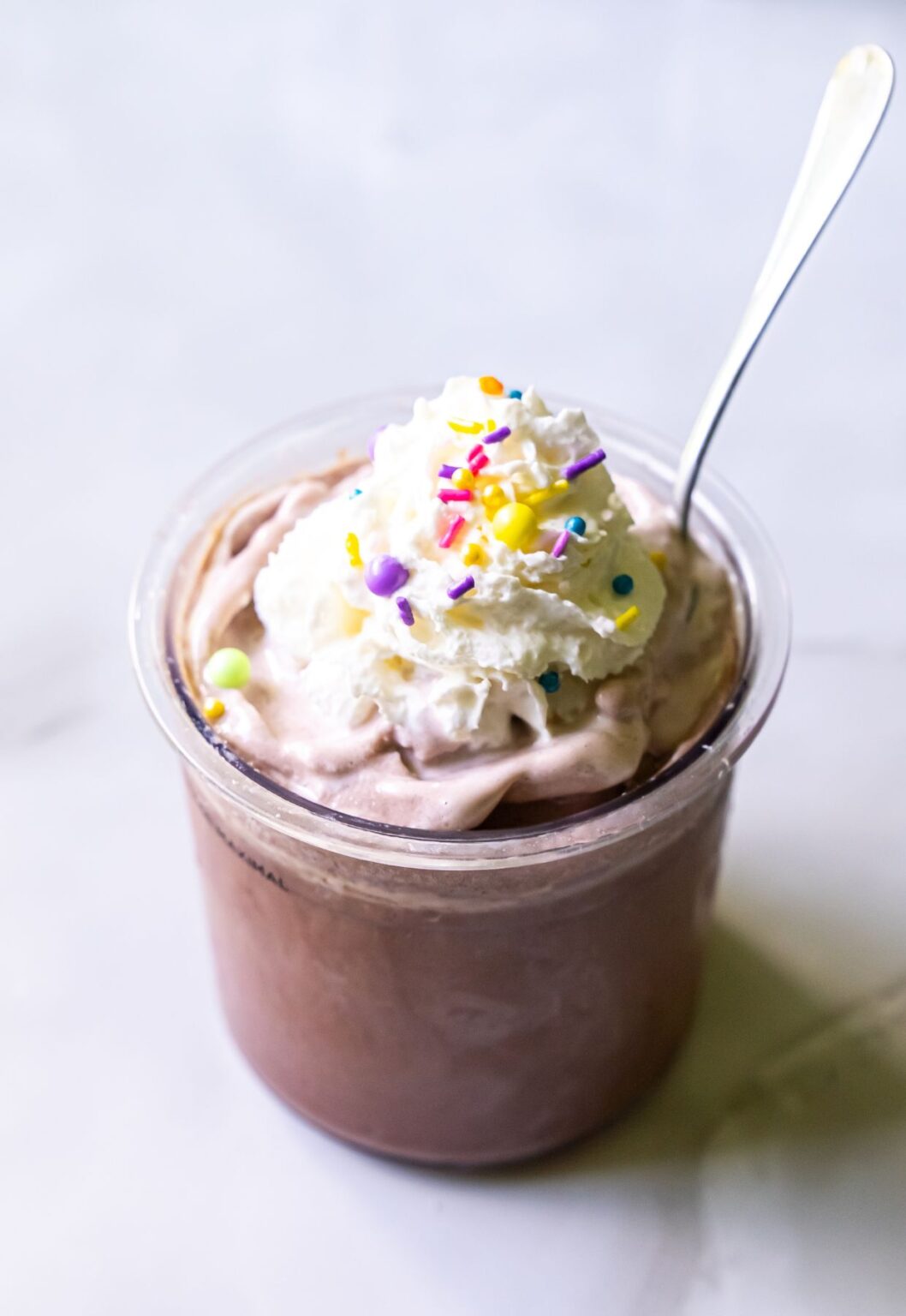 chocolate ice cream with whipped cream and sprinkles.