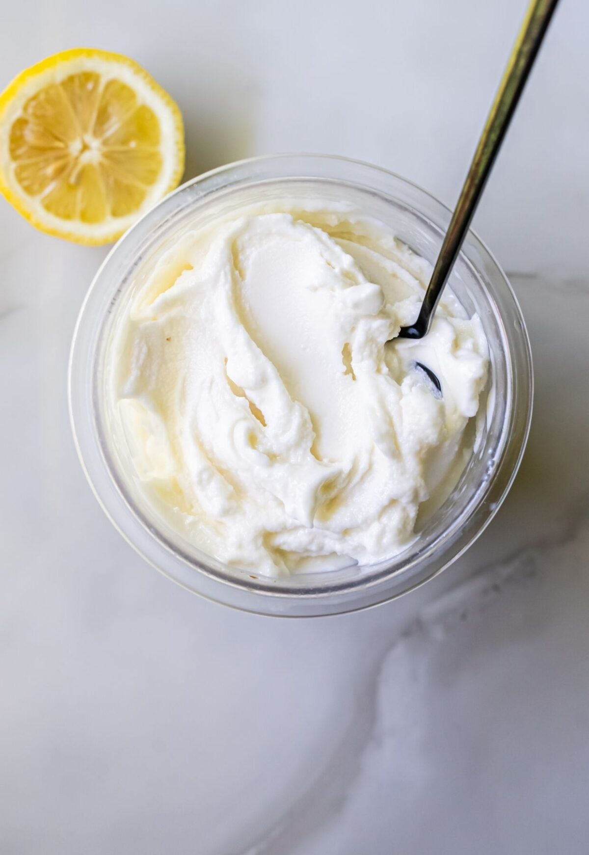 Top view of lemon protein ice cream with a spoon.