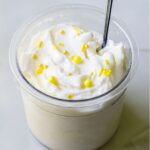 lemon protein ice ream with sprinkles and a spoon.