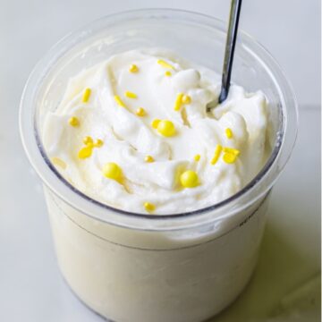 lemon protein ice ream with sprinkles and a spoon.