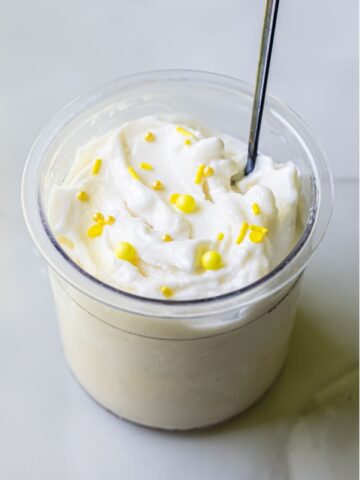 lemon protein ice ream with sprinkles and a spoon.