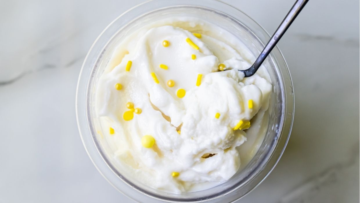 lemon protein ice ream with sprinkles and a spoon.