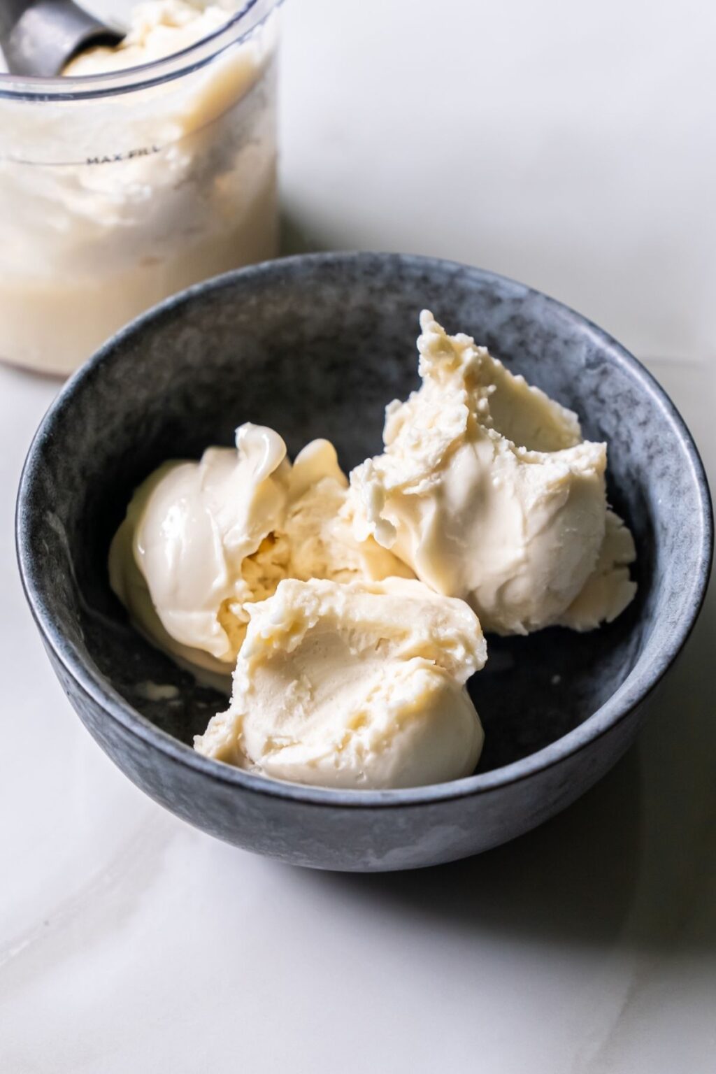 A black bowl filled with three scoops of creamy ice cream, made using the Ninja Creami.