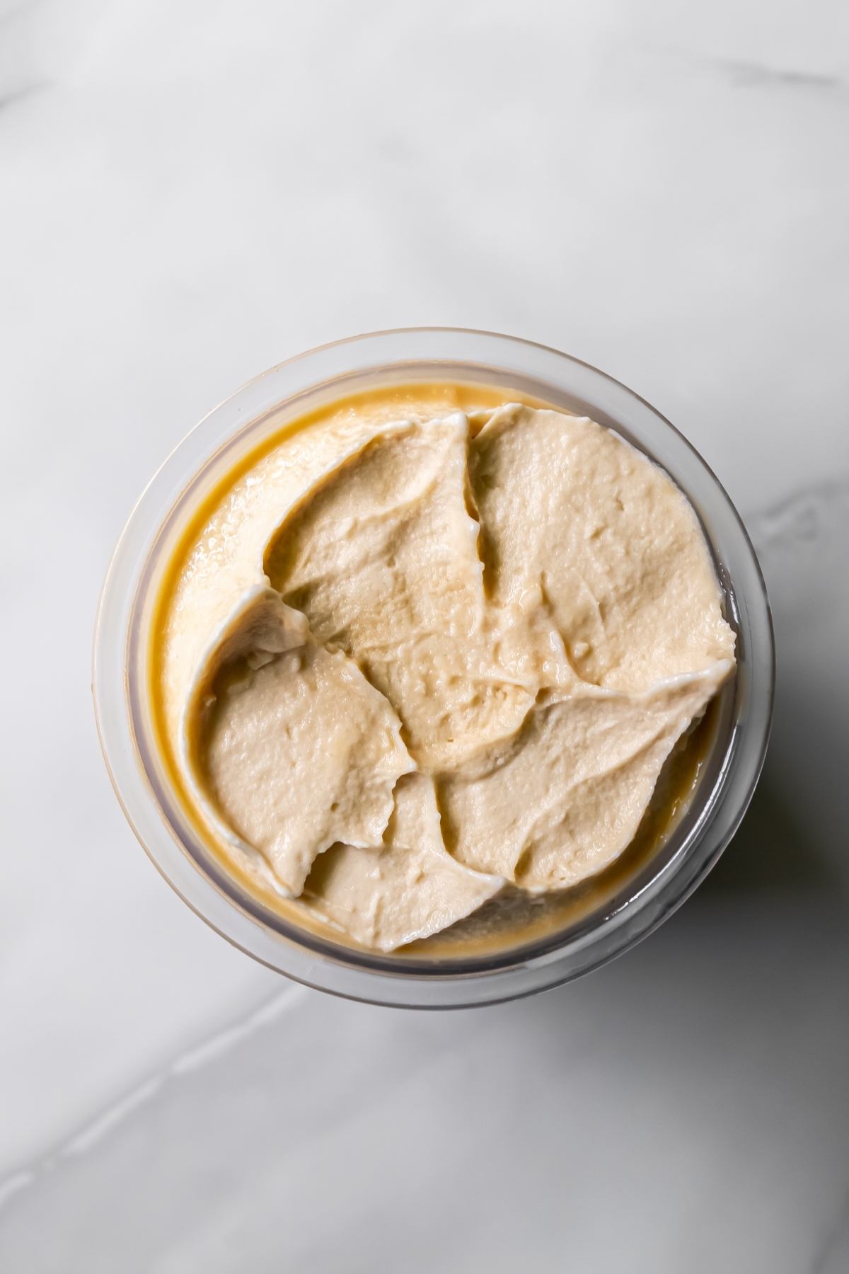 Top view of Oat Milk Protein Coffee ice cream in a clear pint