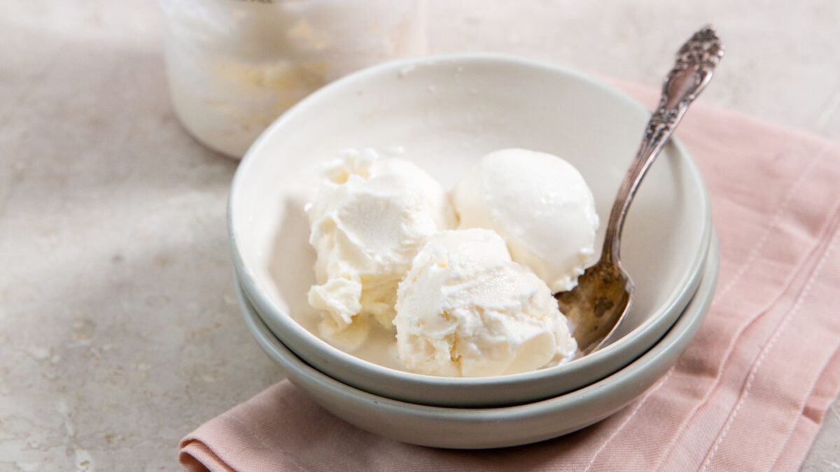 Ninja Creami Vanilla Ice cream in a white bowl with a pink napkin and spoon.