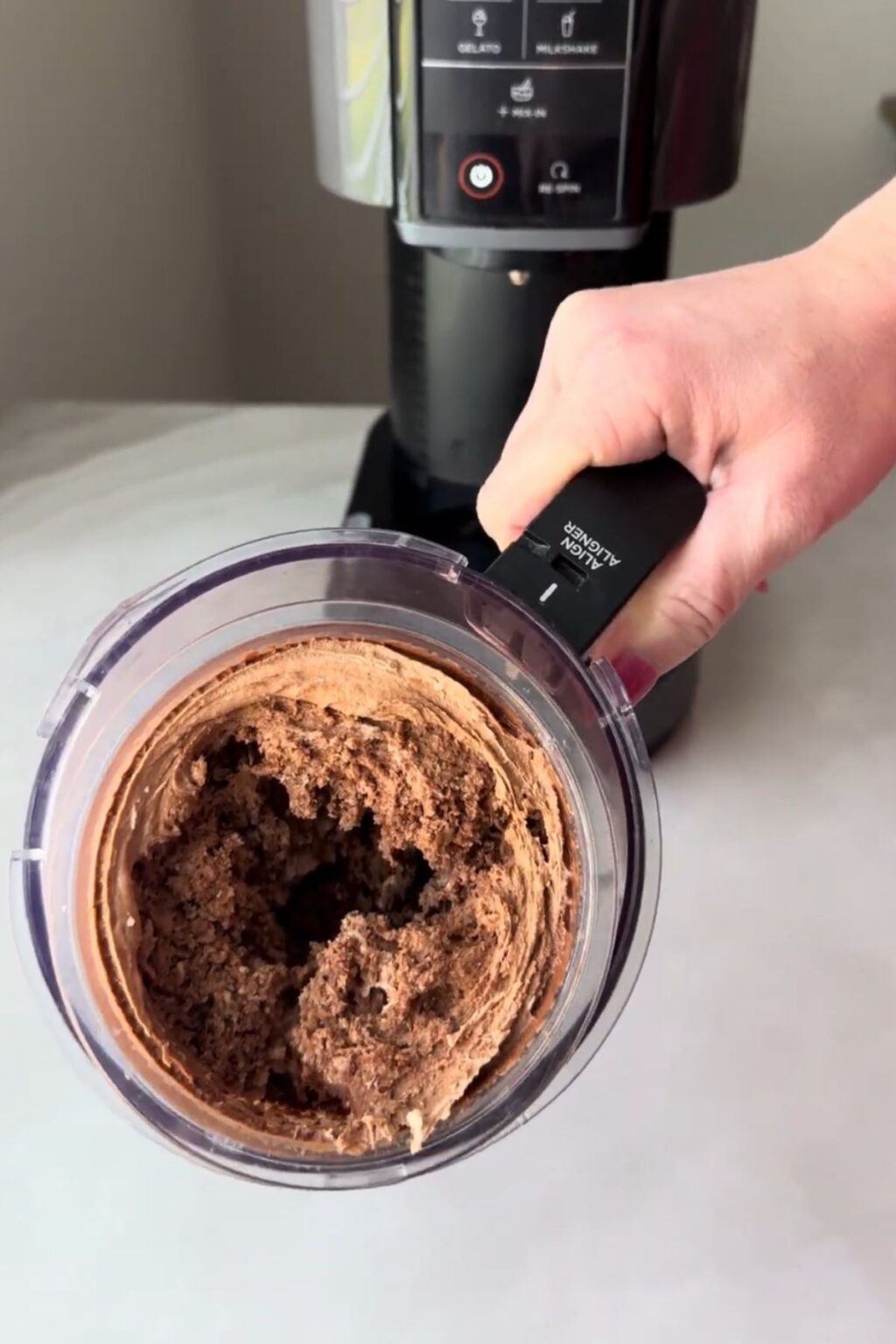 Top-down view of churned Thin Mint Protein Ice Cream in pint after initial spin.